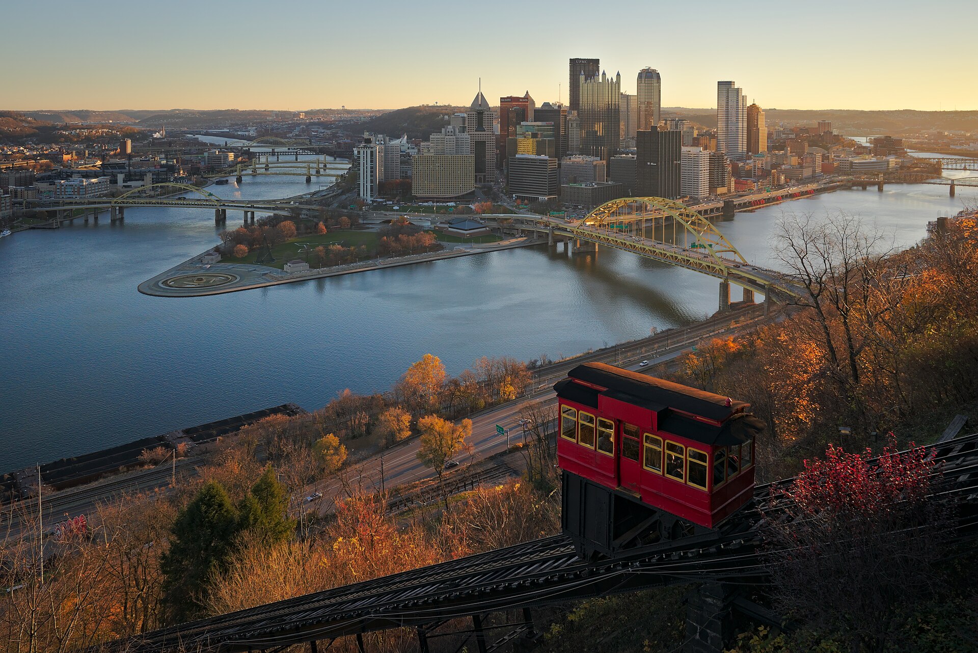Duquesne Incline car above Pittsburgh's Point and rivers at golden hour