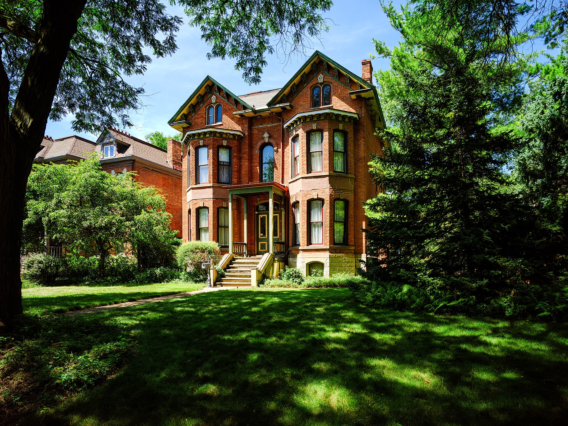 Victorian brick house with a shaded lawn in Detroit's West Canfield district