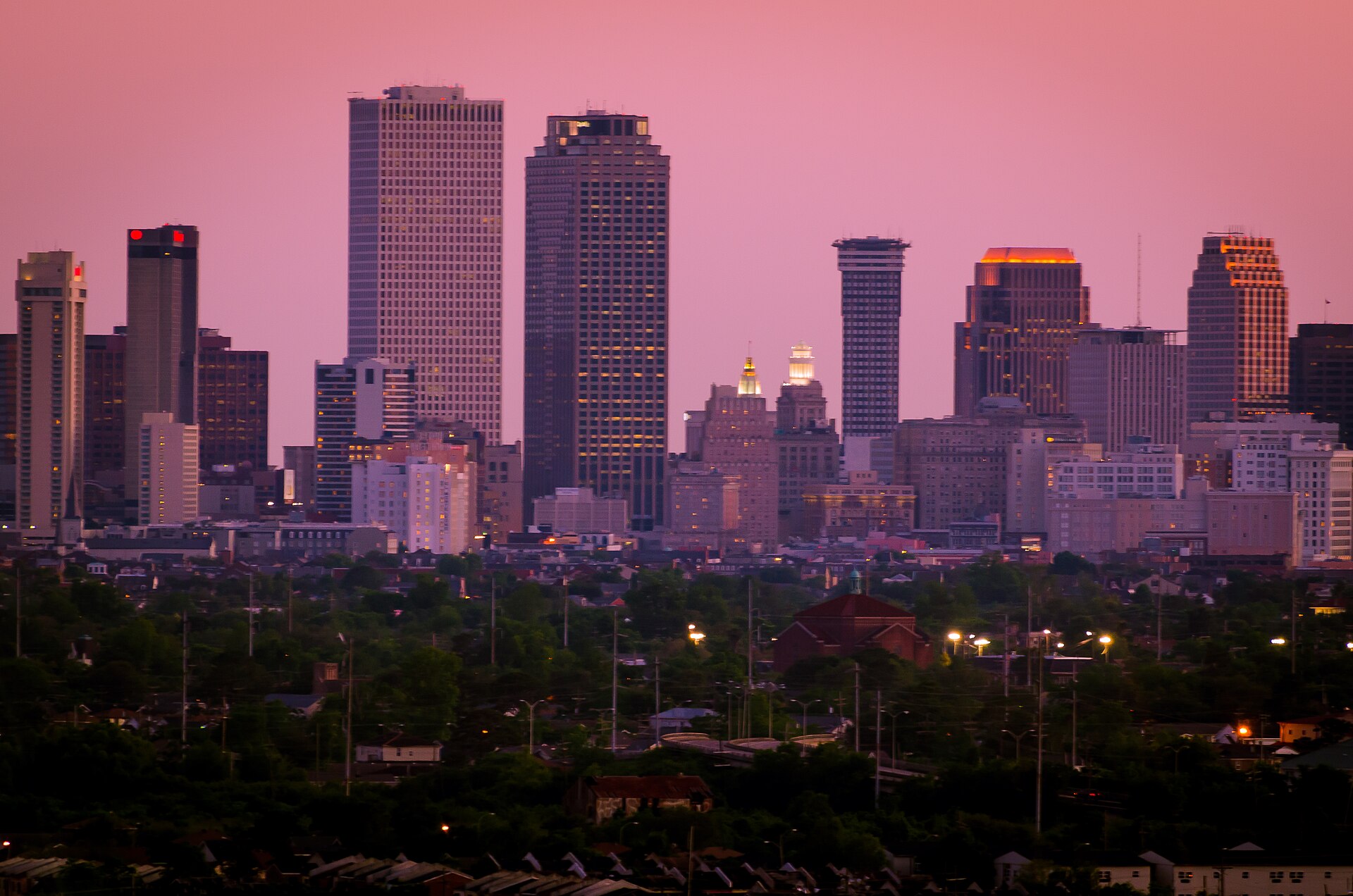 New Orleans downtown skyline under a pink dusk sky
