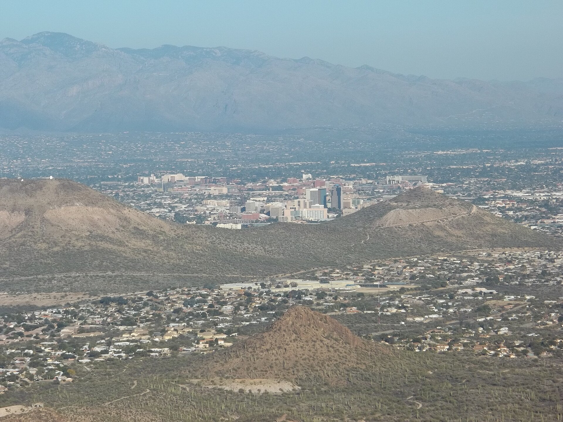 Downtown Tucson between desert hills with the Santa Catalina Mountains behind