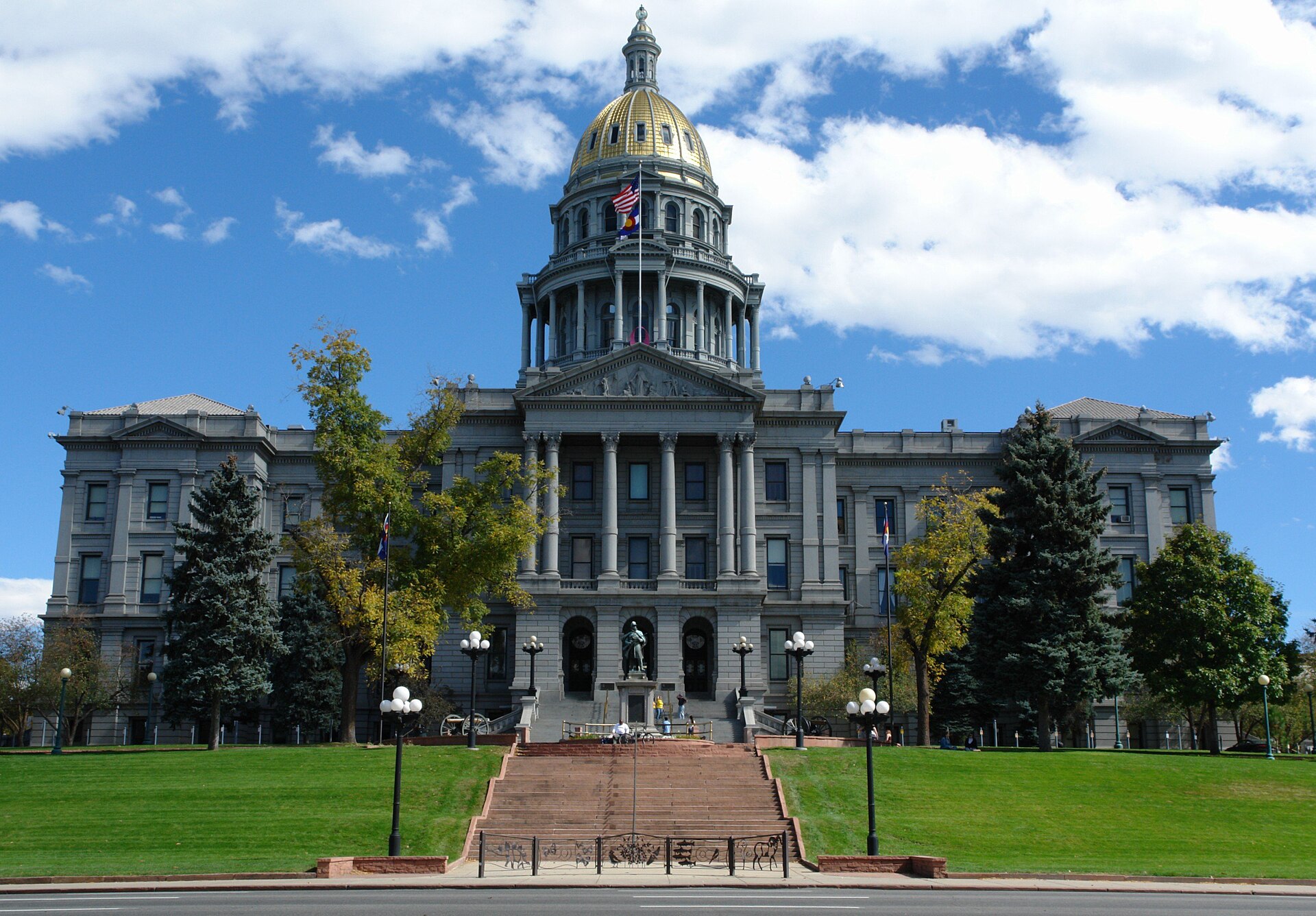 Colorado State Capitol with gold dome under blue sky in Denver