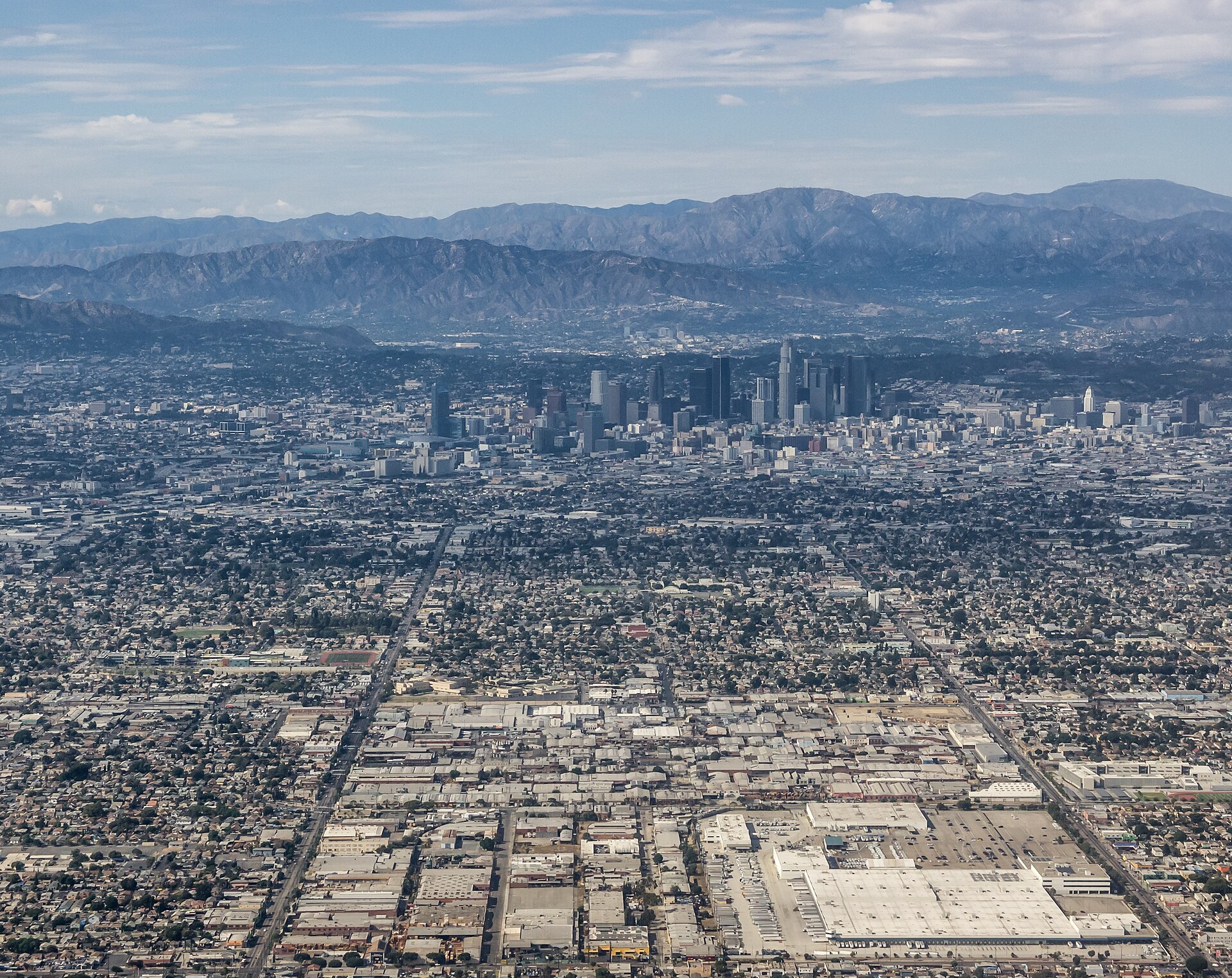 Aerial view of Los Angeles sprawl and downtown skyline with mountains